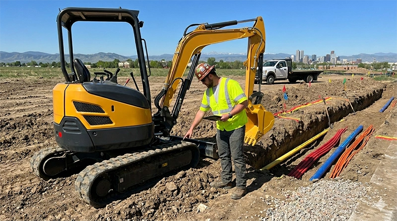 Mini excavator operator conducting pre-operation safety inspection